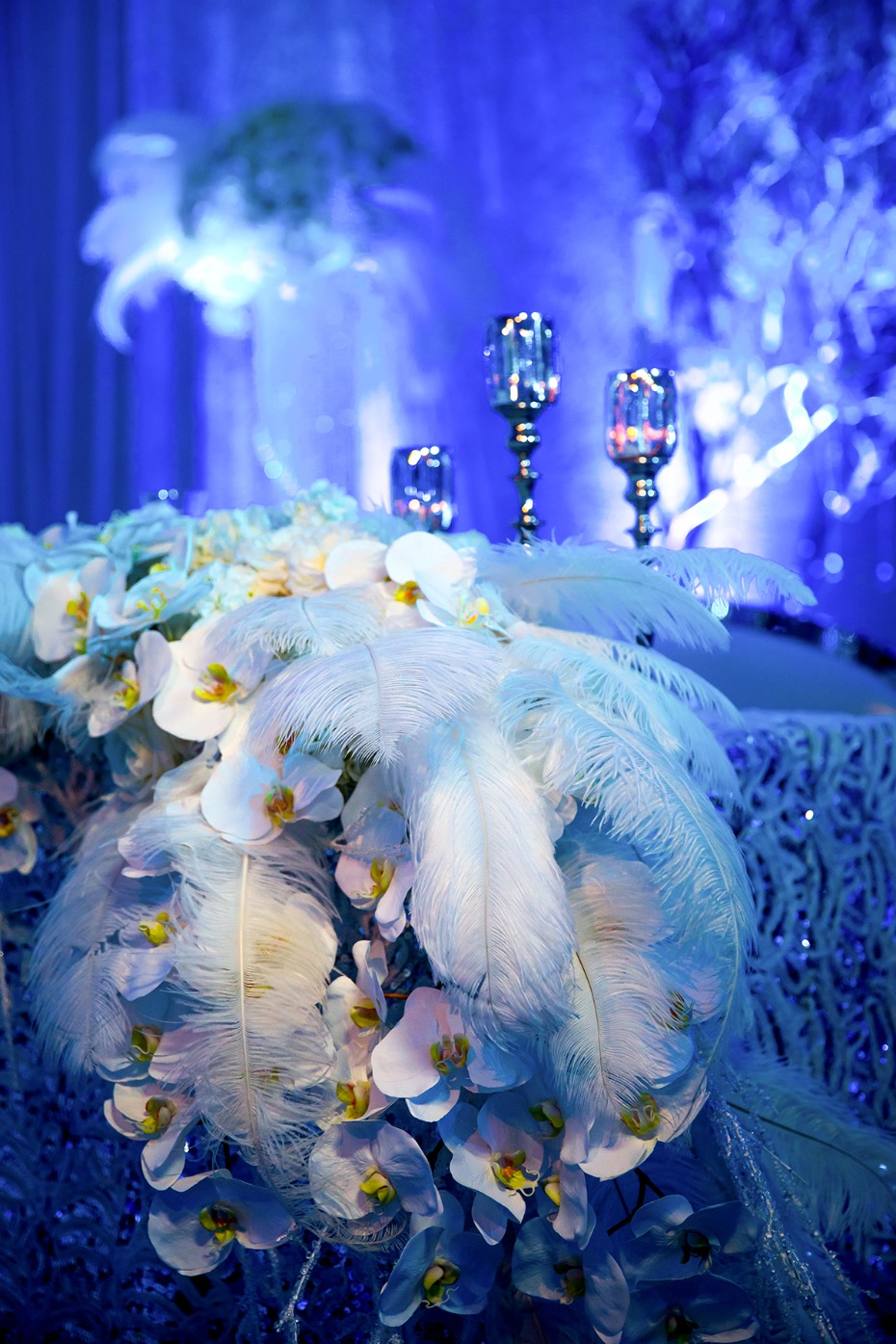 glamorous feathers and orchid winter wedding reception decor