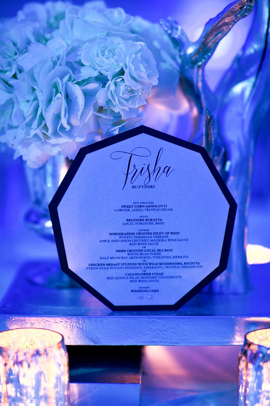Elegant wedding menu card with floral decorations in blue light