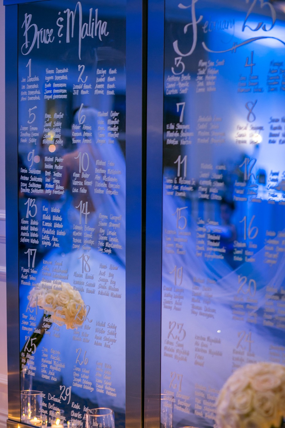 Elegant wedding seating chart with bride in background