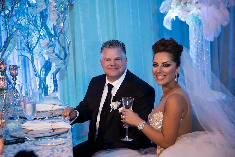 Bride and groom smiling at wedding reception with beautiful decor