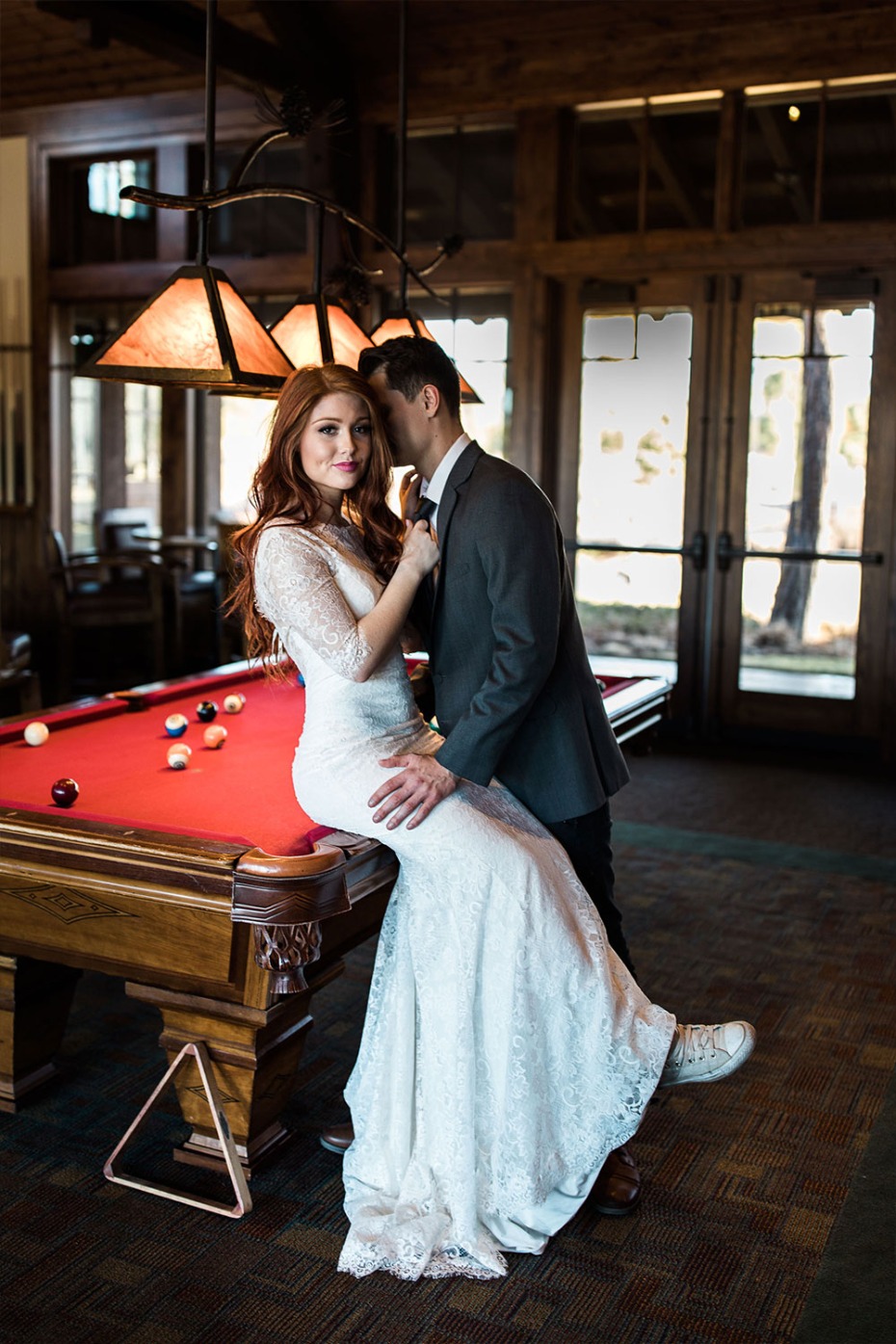 bride and groom playing pool