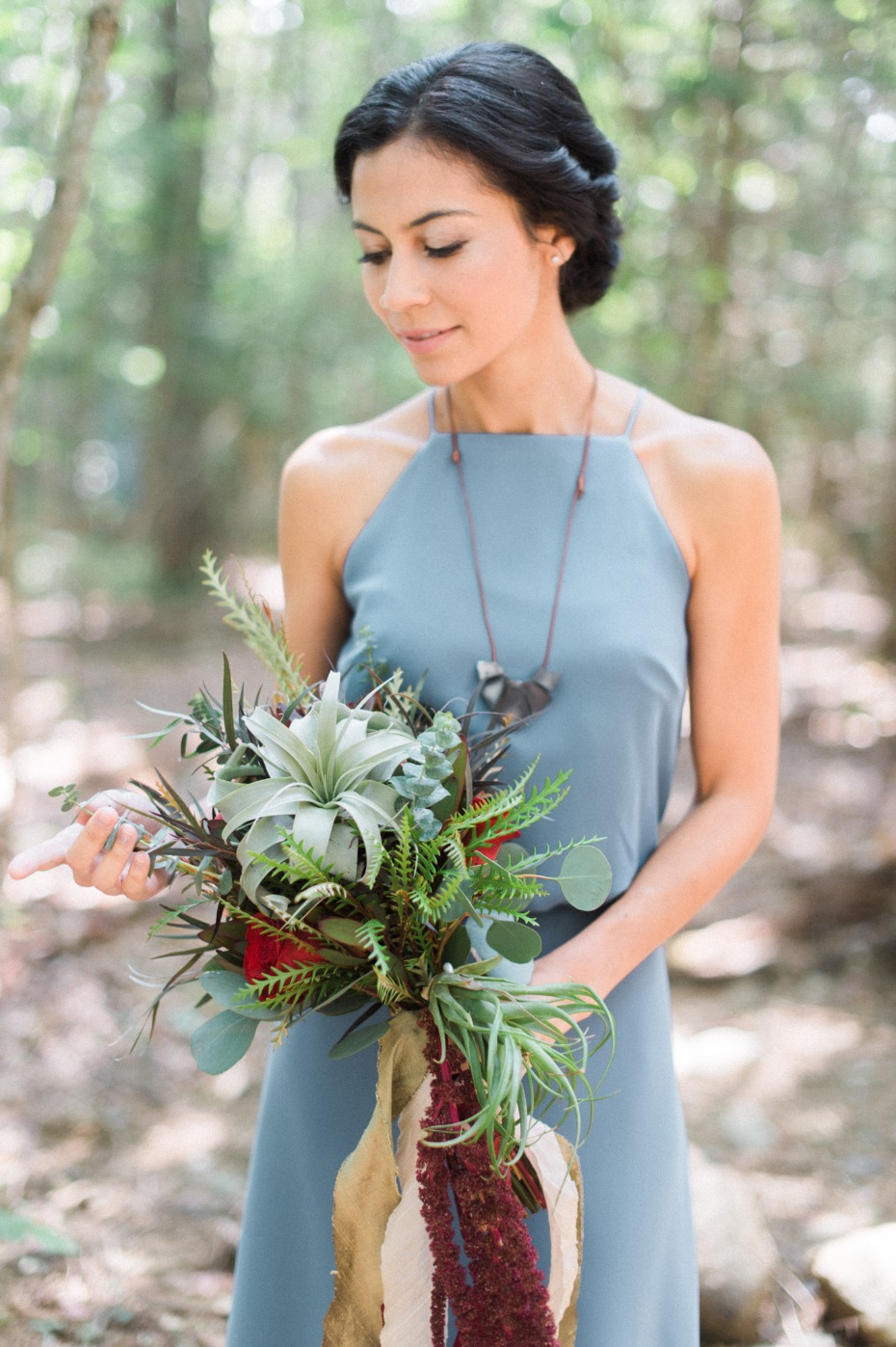 Bridesmaid in blue with air plant bouquet