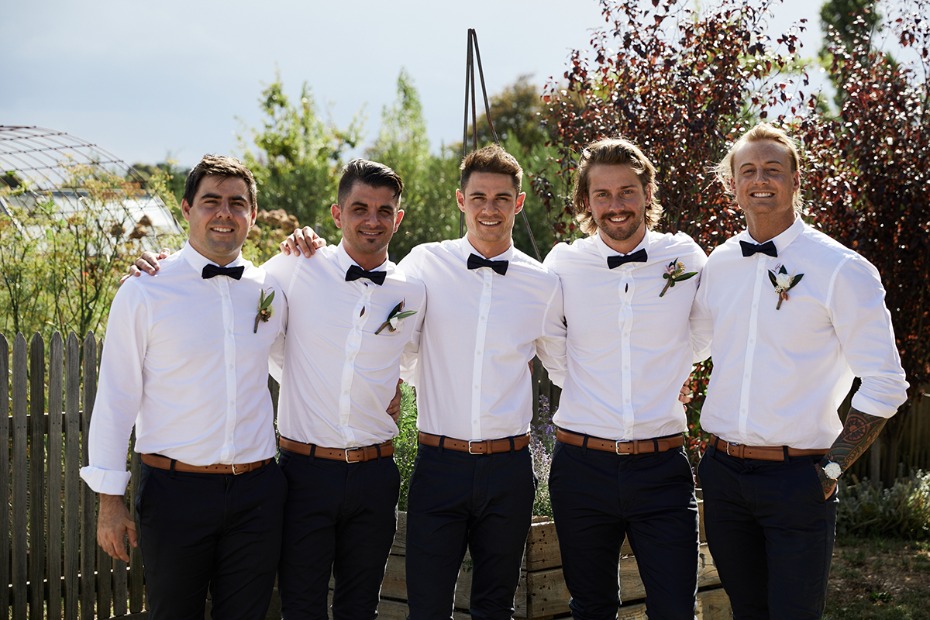 grooms men and groom in white and black
