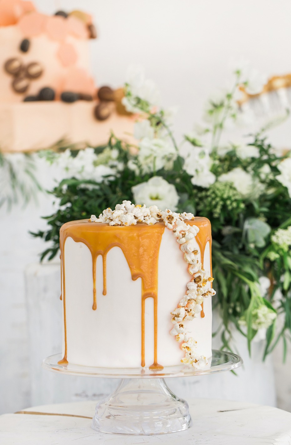 caramel dip and popcorn topped cake
