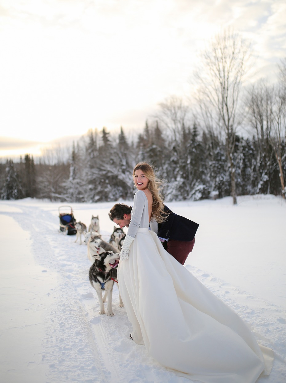 a bride a groom and a team of huskies