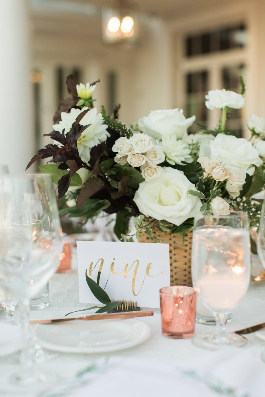 Contemporary centerpiece with white blooms and rose gold accents