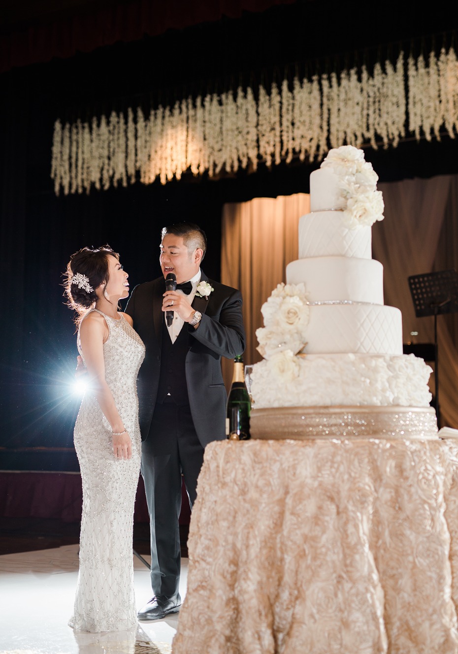 bride and groom and their towering cake