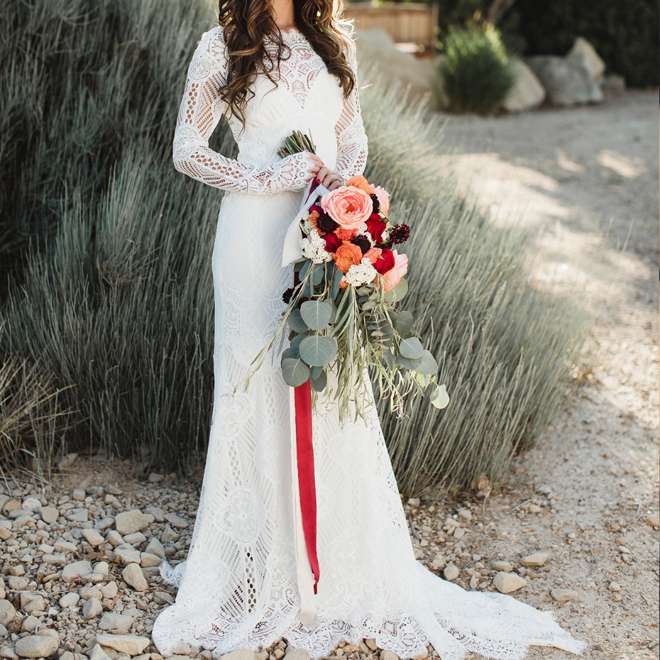 Bride in a lace wedding dress holding a bouquet