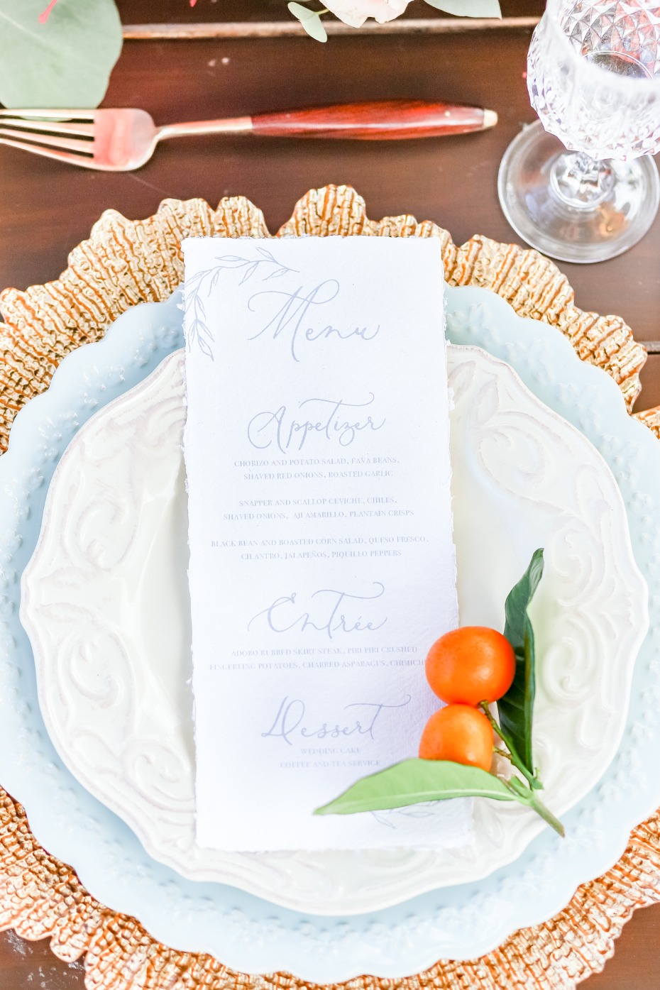 Elegant menu card on a beautifully set table with orange garnish