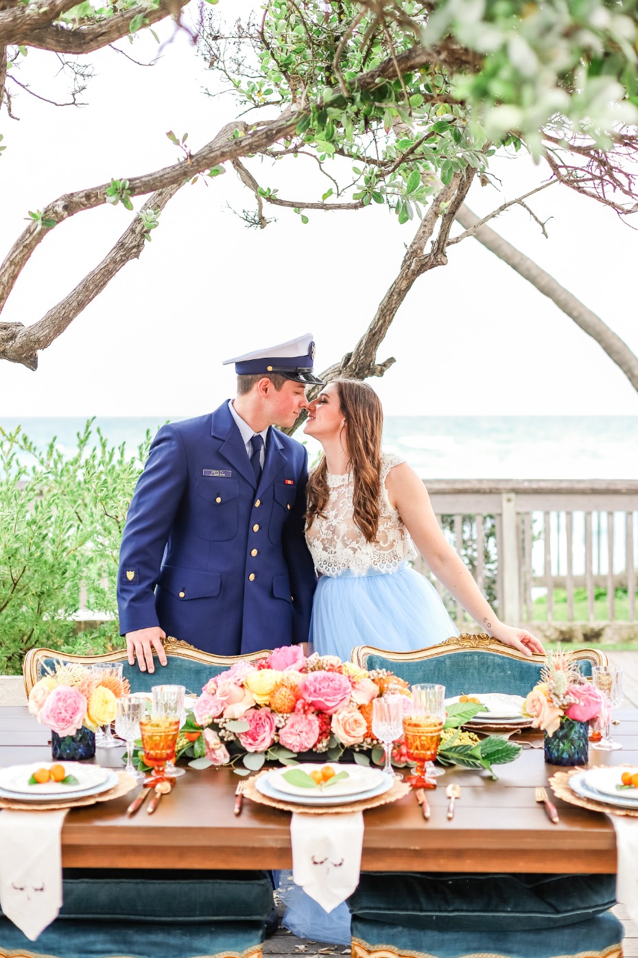 Couple kissing near table during a romantic beach wedding