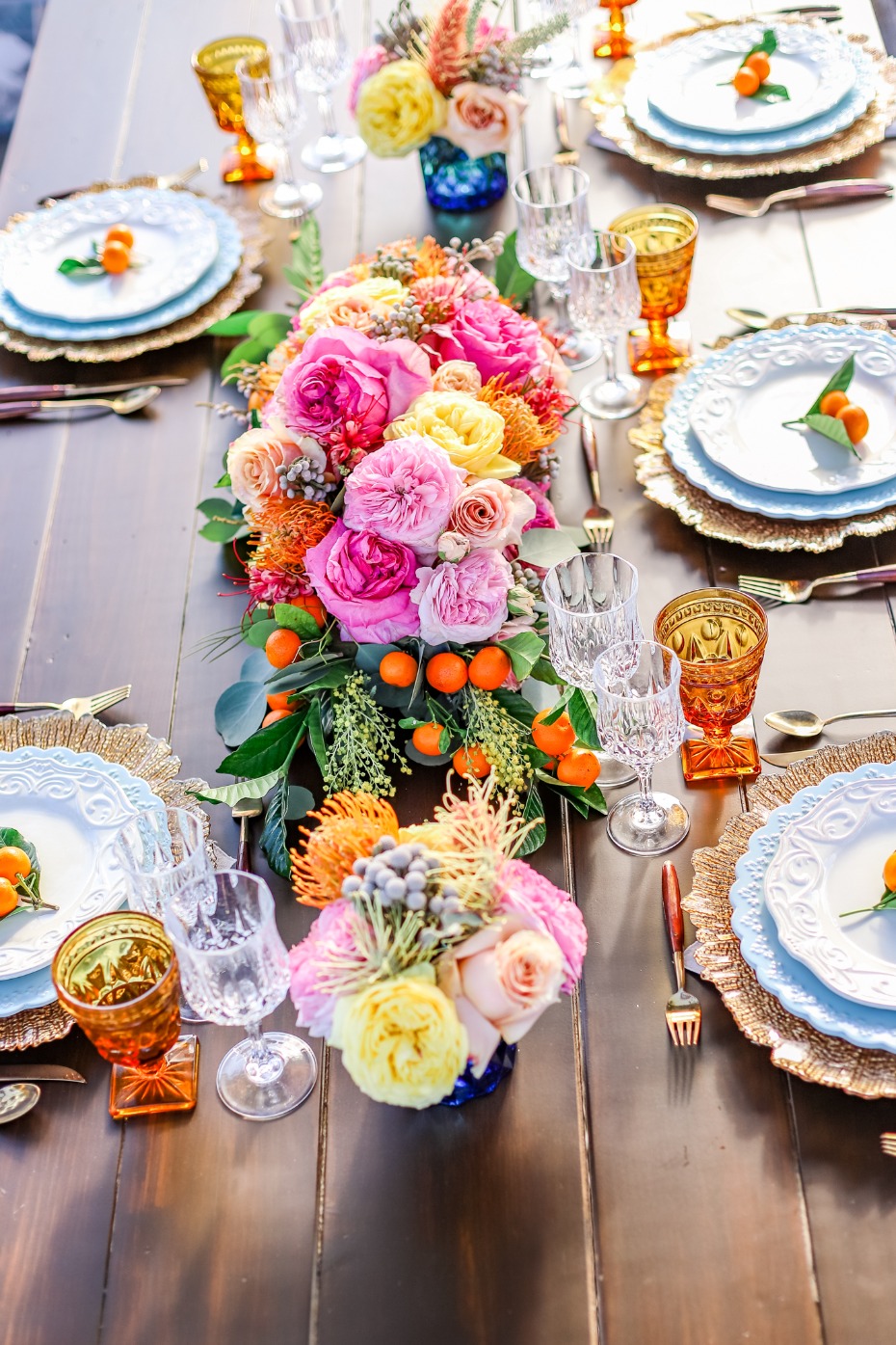 Elegant table setting with vibrant floral centerpiece and dishes