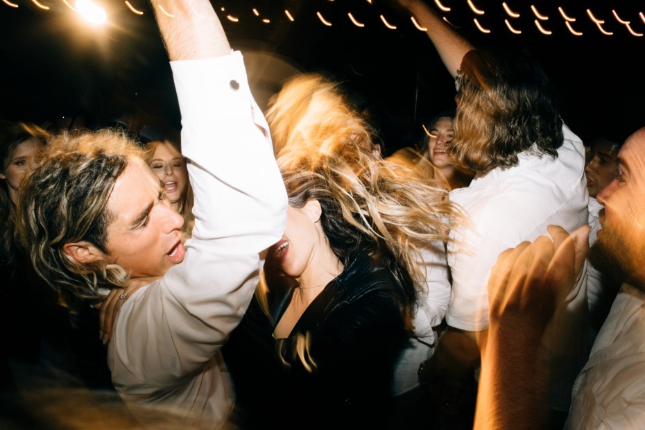 People dancing and having fun in a dark room with lights on