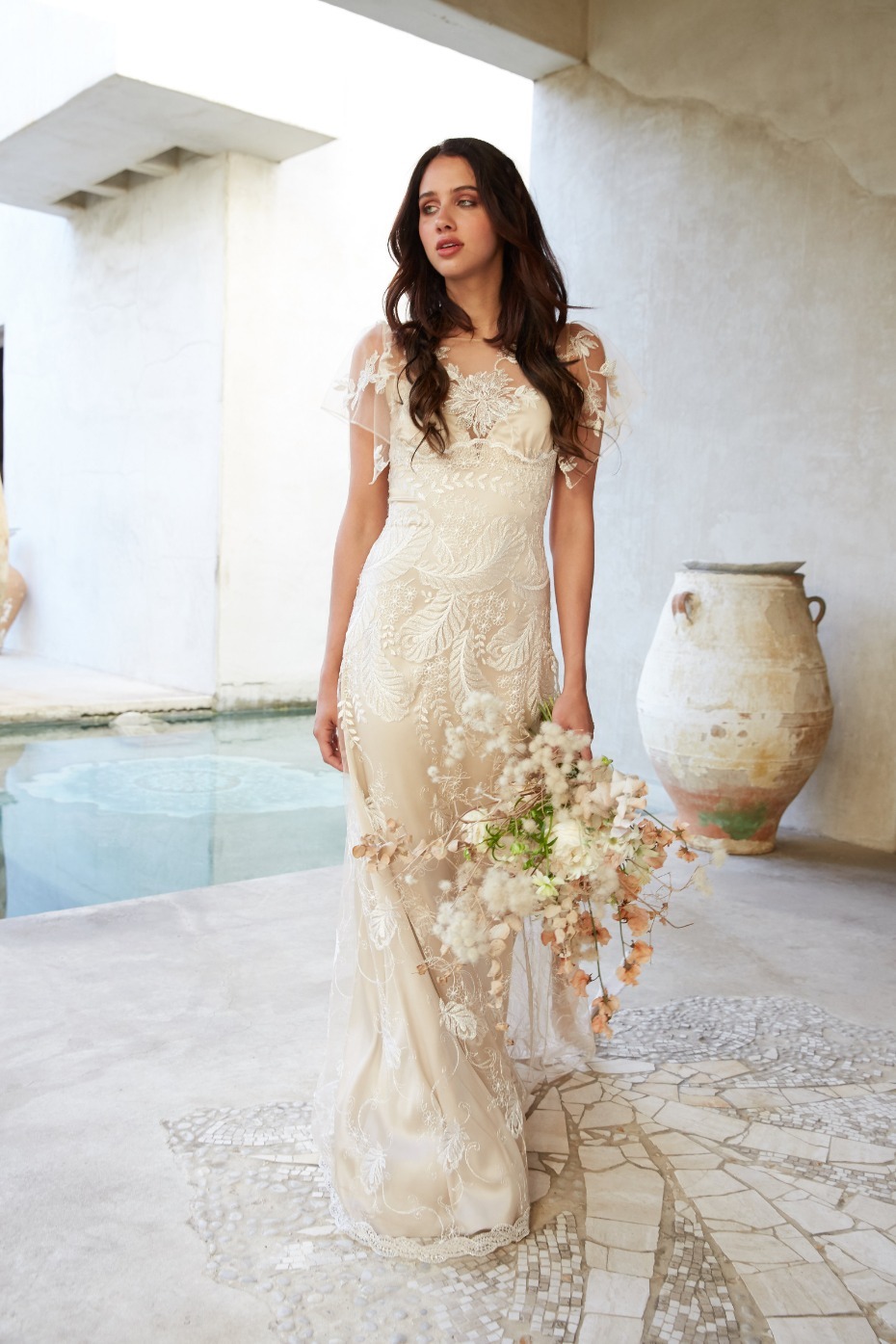 Bride in lace wedding dress holding floral bouquet