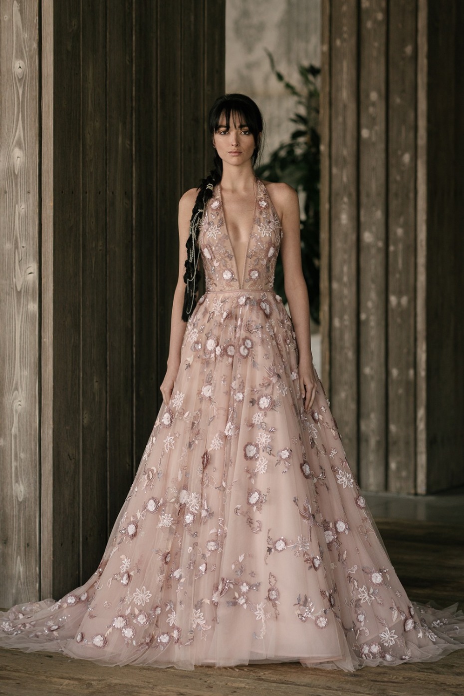 Woman in a pink floral embroidered halter neck gown