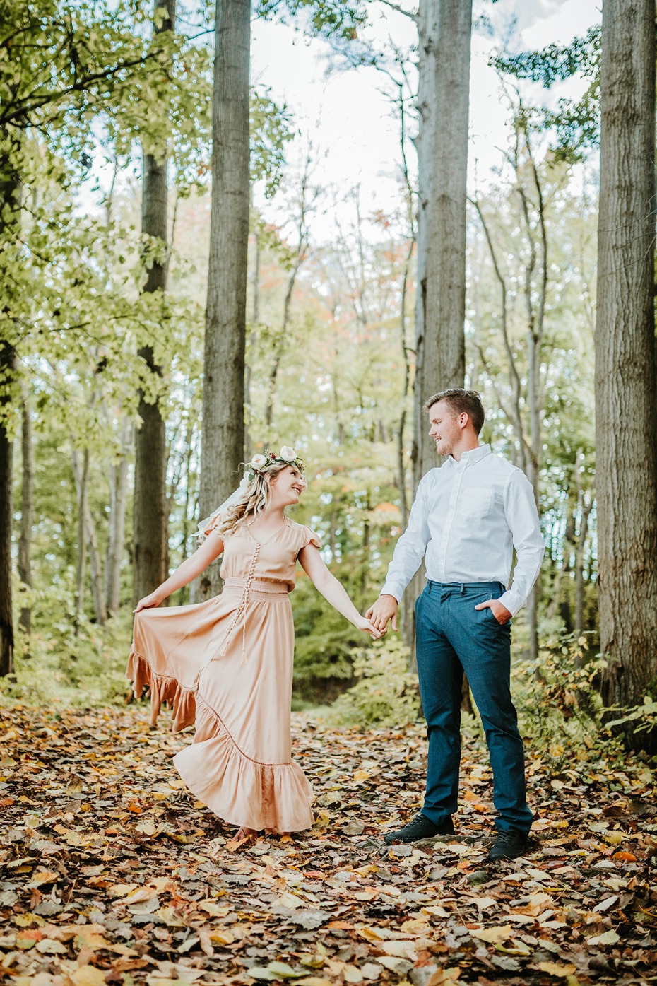 Romantic couple holding hands in an autumn forest scene