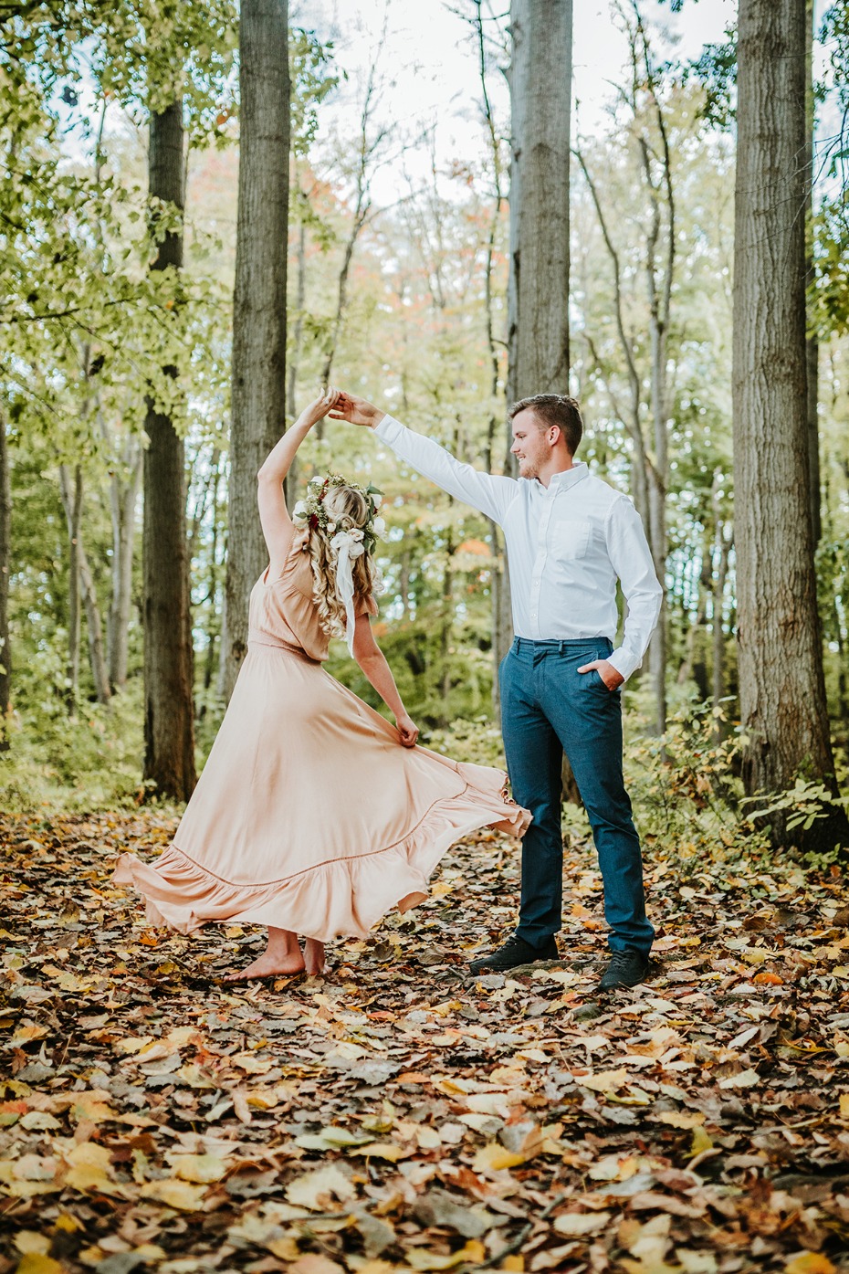 Couple dancing in autumn woods barefoot and carefree