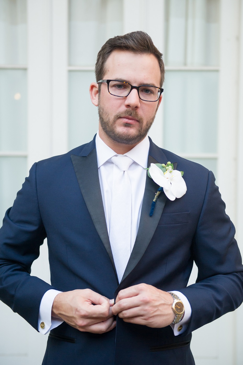 groom in sleek navy and suit