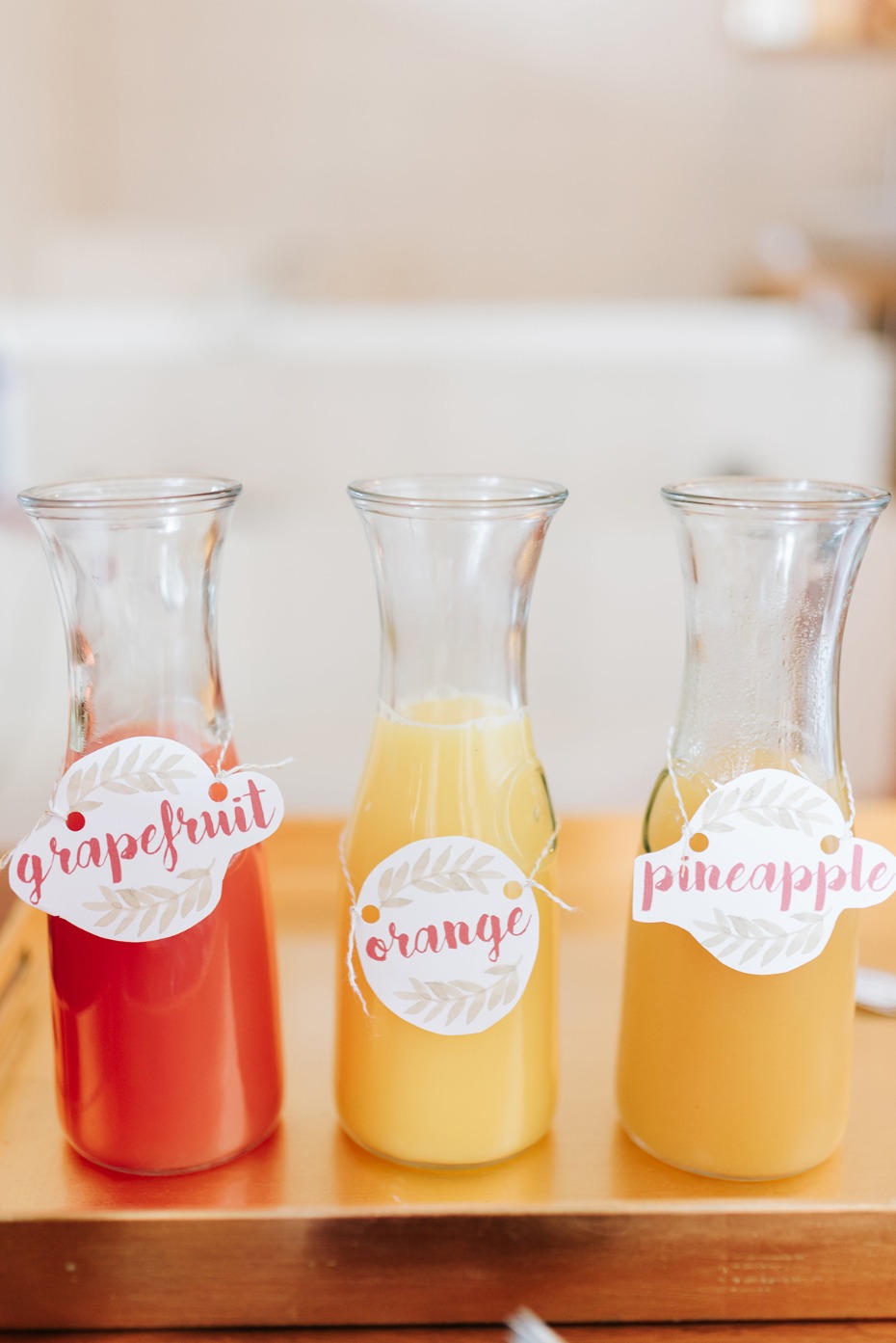 Three juices in glass bottles grapefruit orange pineapple