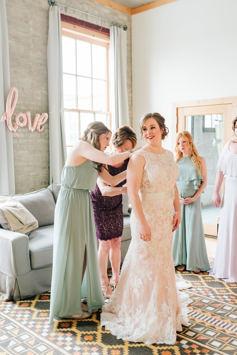 Bride getting ready with bridesmaids on wedding day