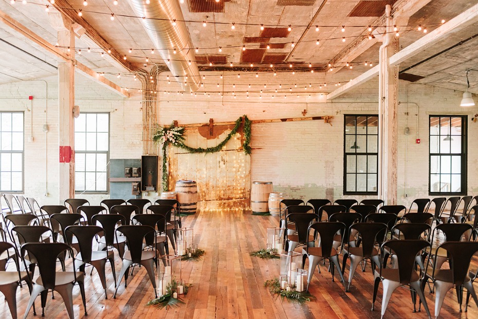 Rustic chic wedding ceremony venue with string lights