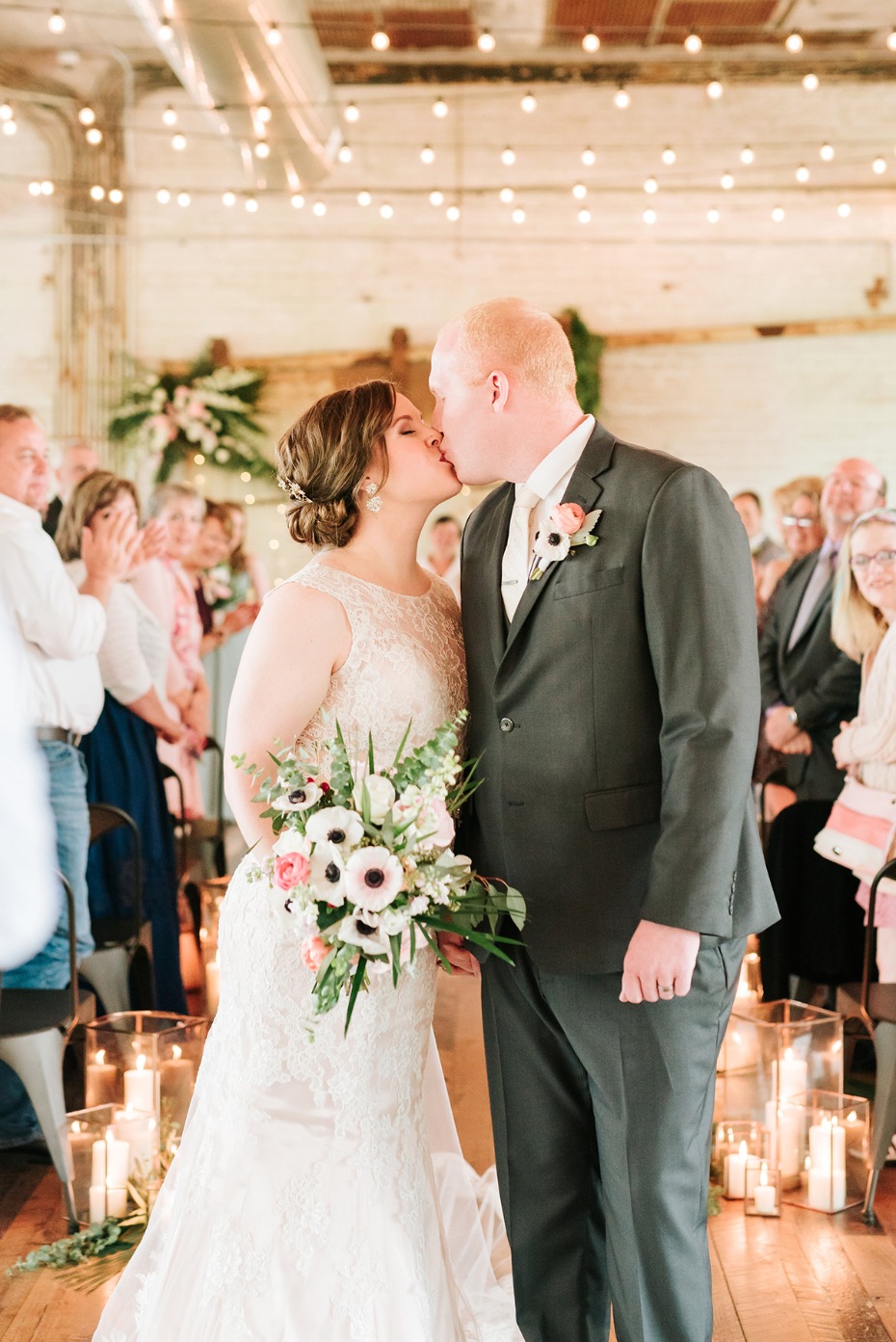 Bride and groom sharing a kiss at their wedding ceremony