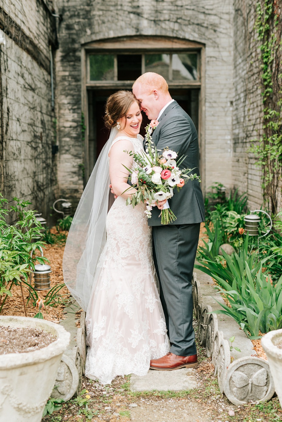 Bride and groom smiling during outdoor wedding ceremony