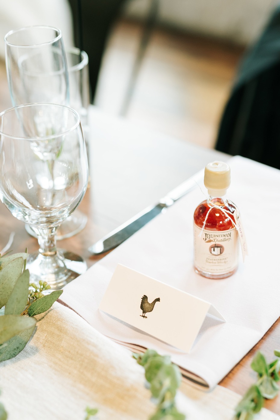 Farm wedding table setting with chicken card and liquor