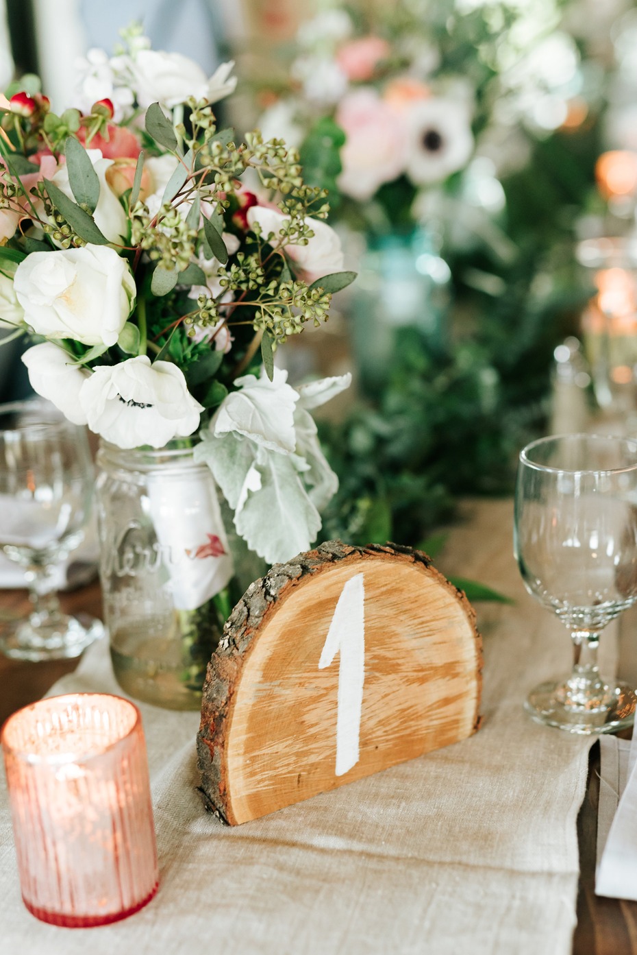 Wedding table setting with flowers and wood table number