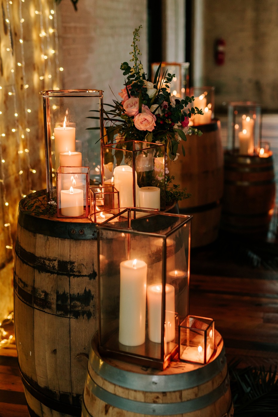 Wedding decor with candles and flowers on rustic barrels