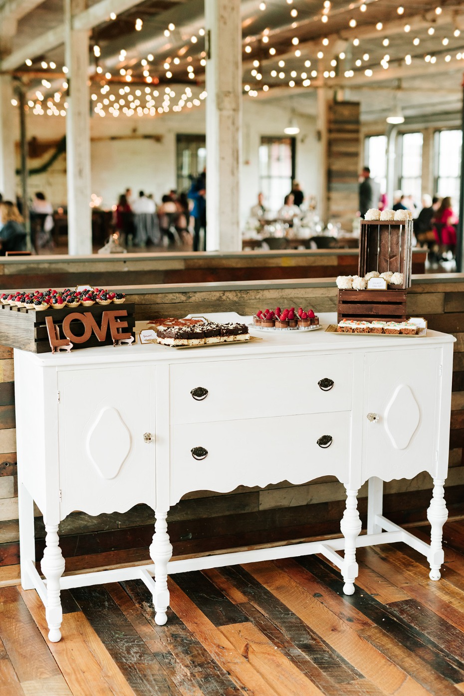 Wedding dessert bar on antique white sideboard buffet