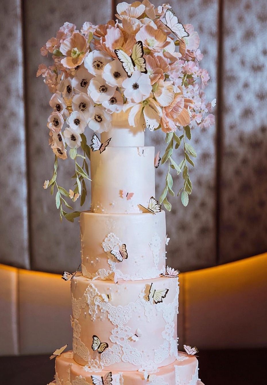 Elegant wedding cake with butterflies and floral decorations