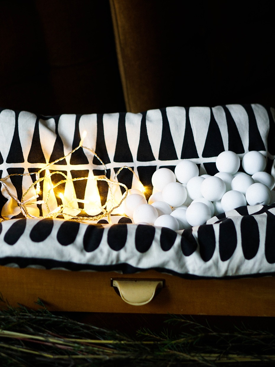 White balls string lights and patterned fabric in box
