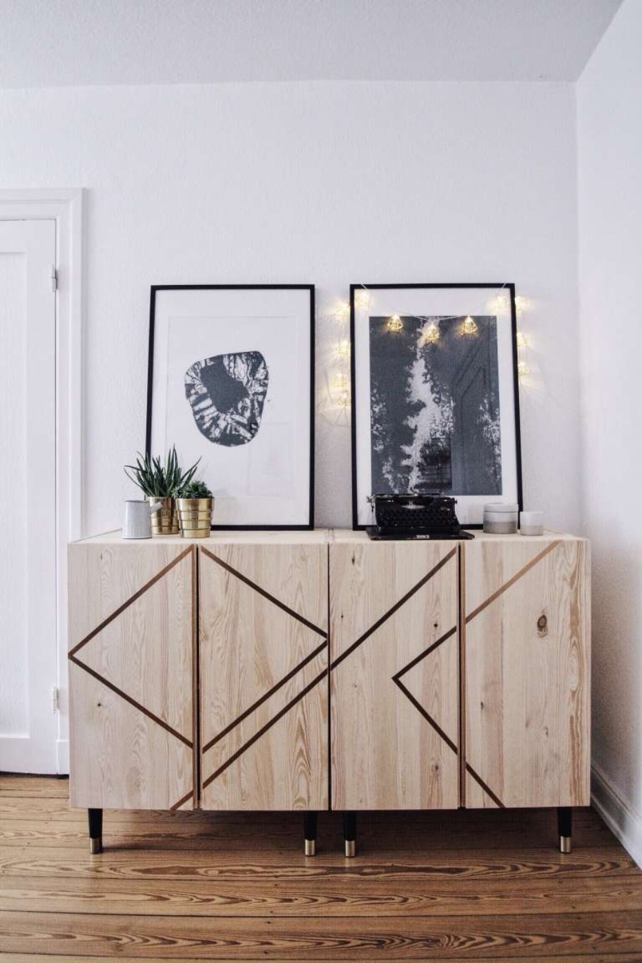 Modern sideboard with abstract art and string lights