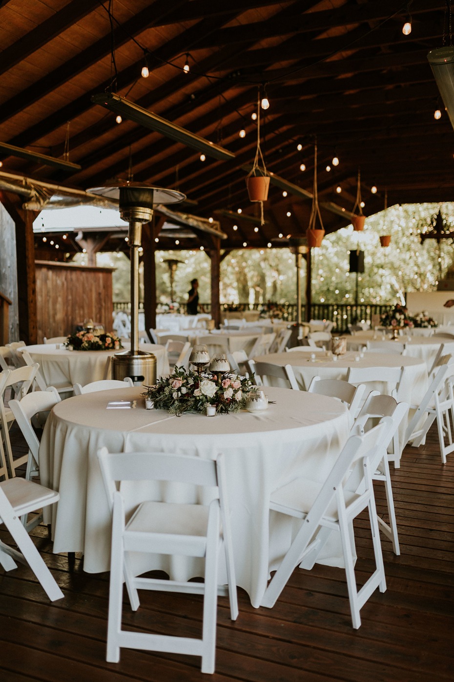Romantic outdoor event setup with tables and lights