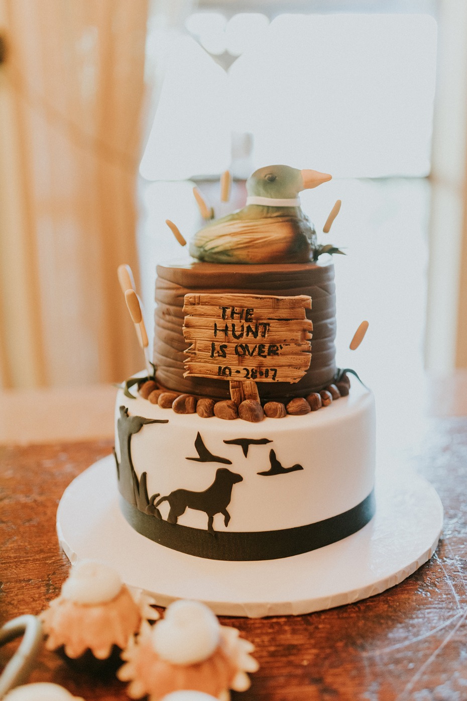 Detailed grooms cake featuring duck and dog silhouettes