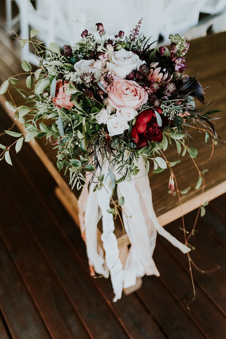 Romantic wedding bouquet with roses and flowing ribbons