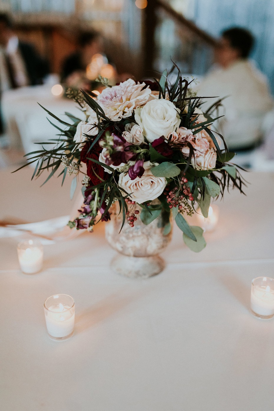 Wedding table decor with floral arrangement and candles