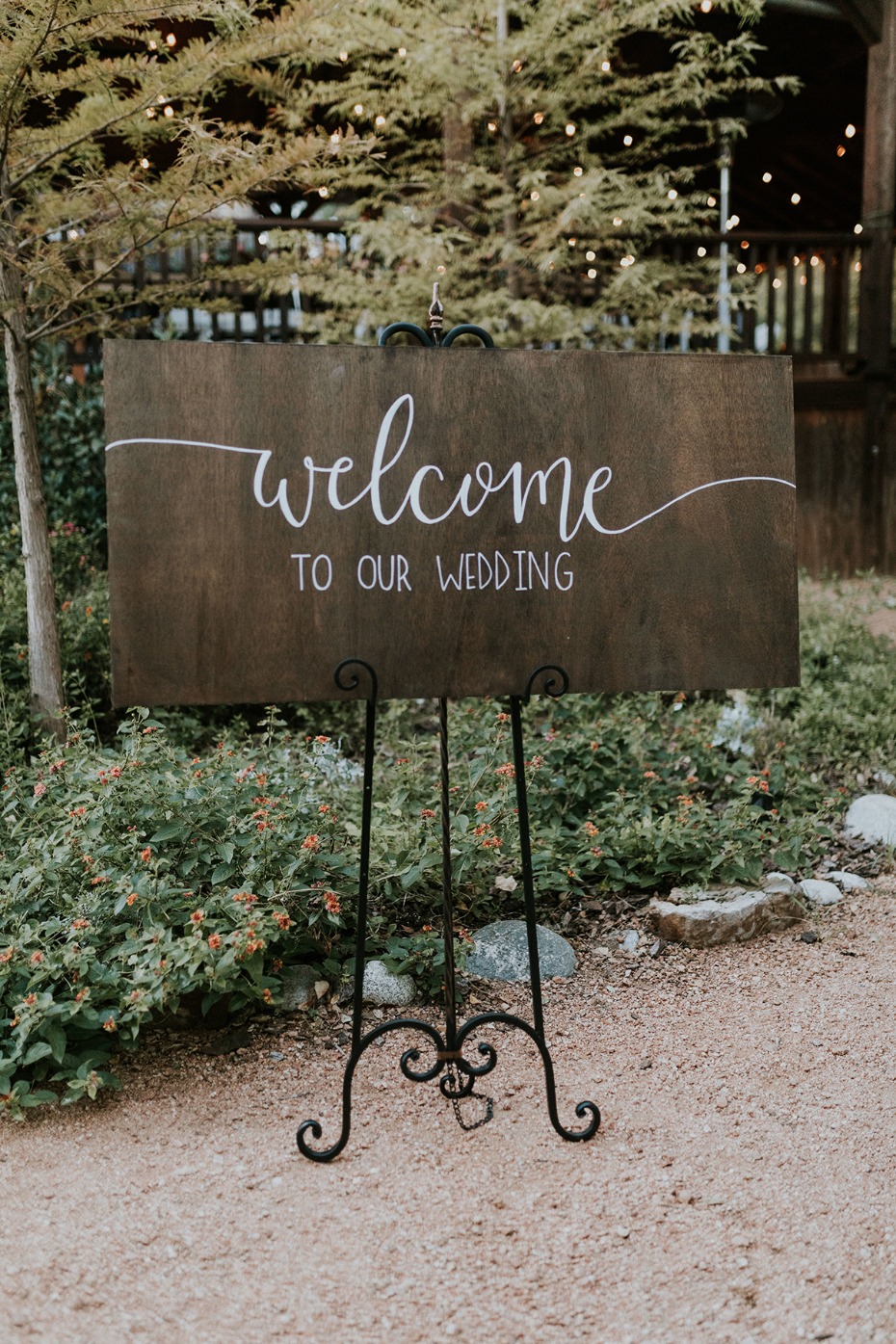 Warm welcome sign greets guests at lovely garden wedding
