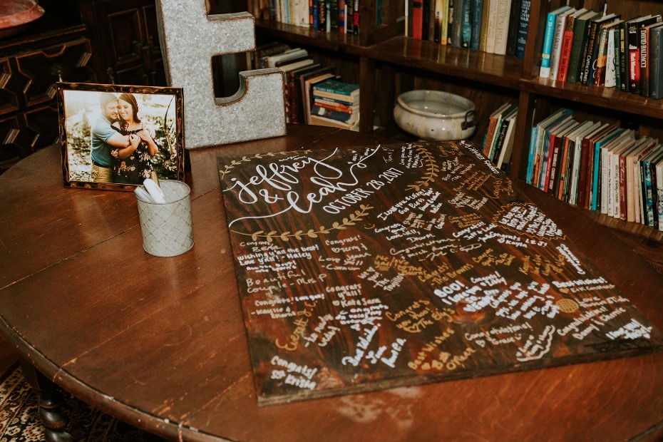Wooden wedding guest book sign with guest heartfelt notes