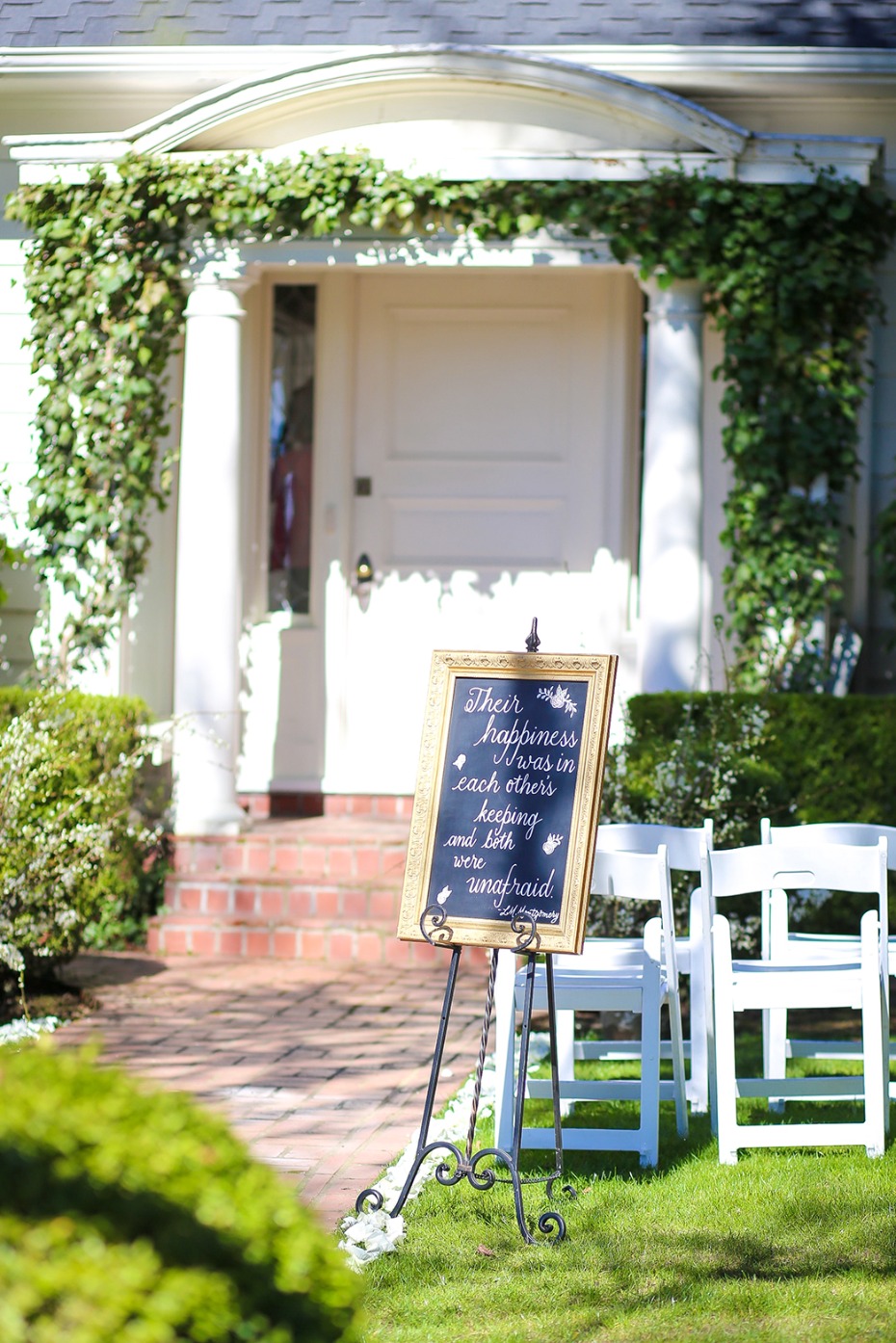 Wedding welcome sign with chairs on the front lawn