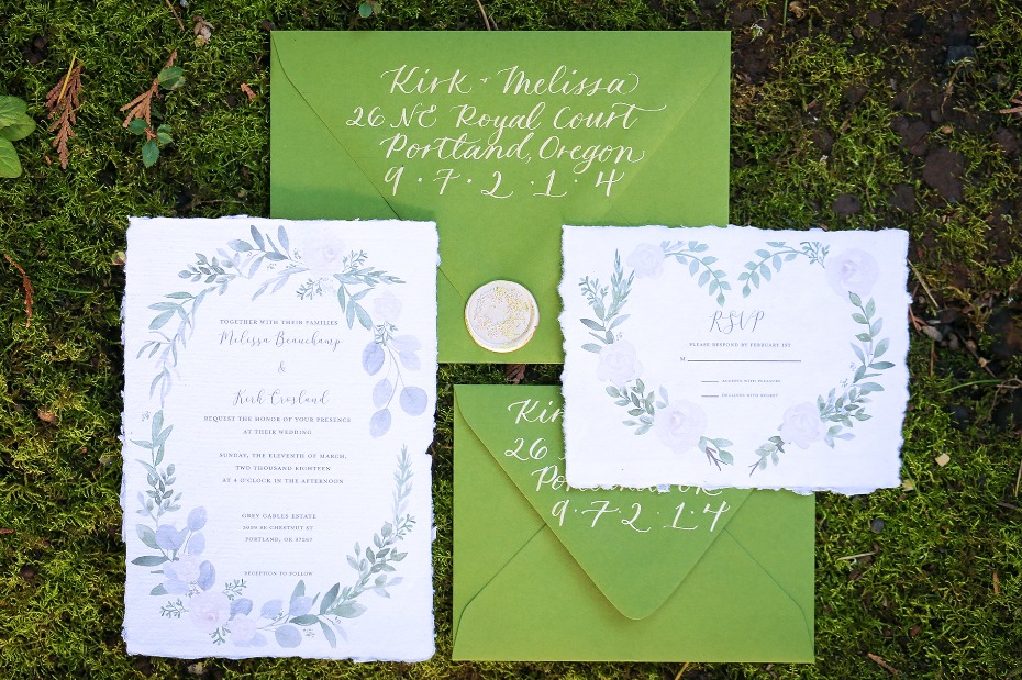 Green floral wedding invitation suite on mossy background