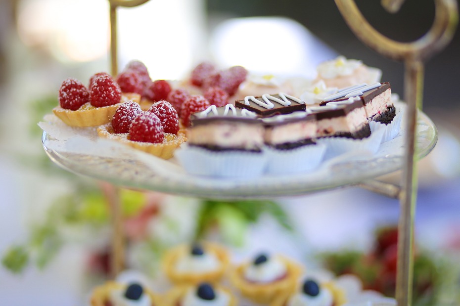 Delicious raspberry tarts and chocolate desserts on a tiered stand