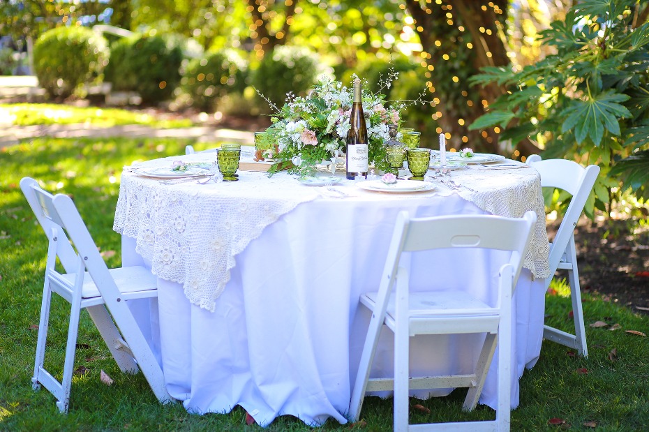 Elegant outdoor dining table setting with white linen
