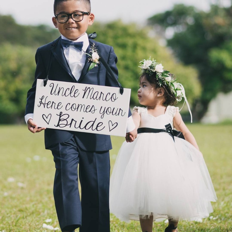 Ring bearer holds sign: Uncle Marco, here comes your bride
