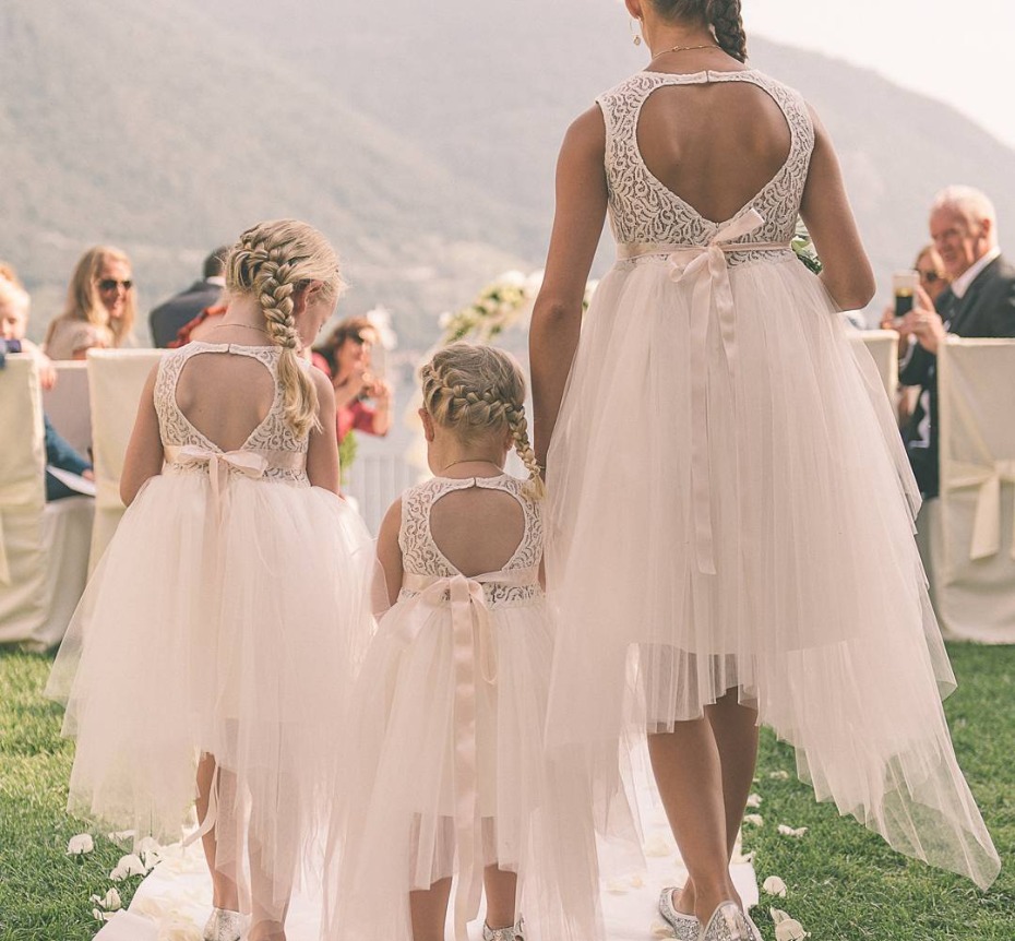 Adorable flower girls in lace dresses at wedding