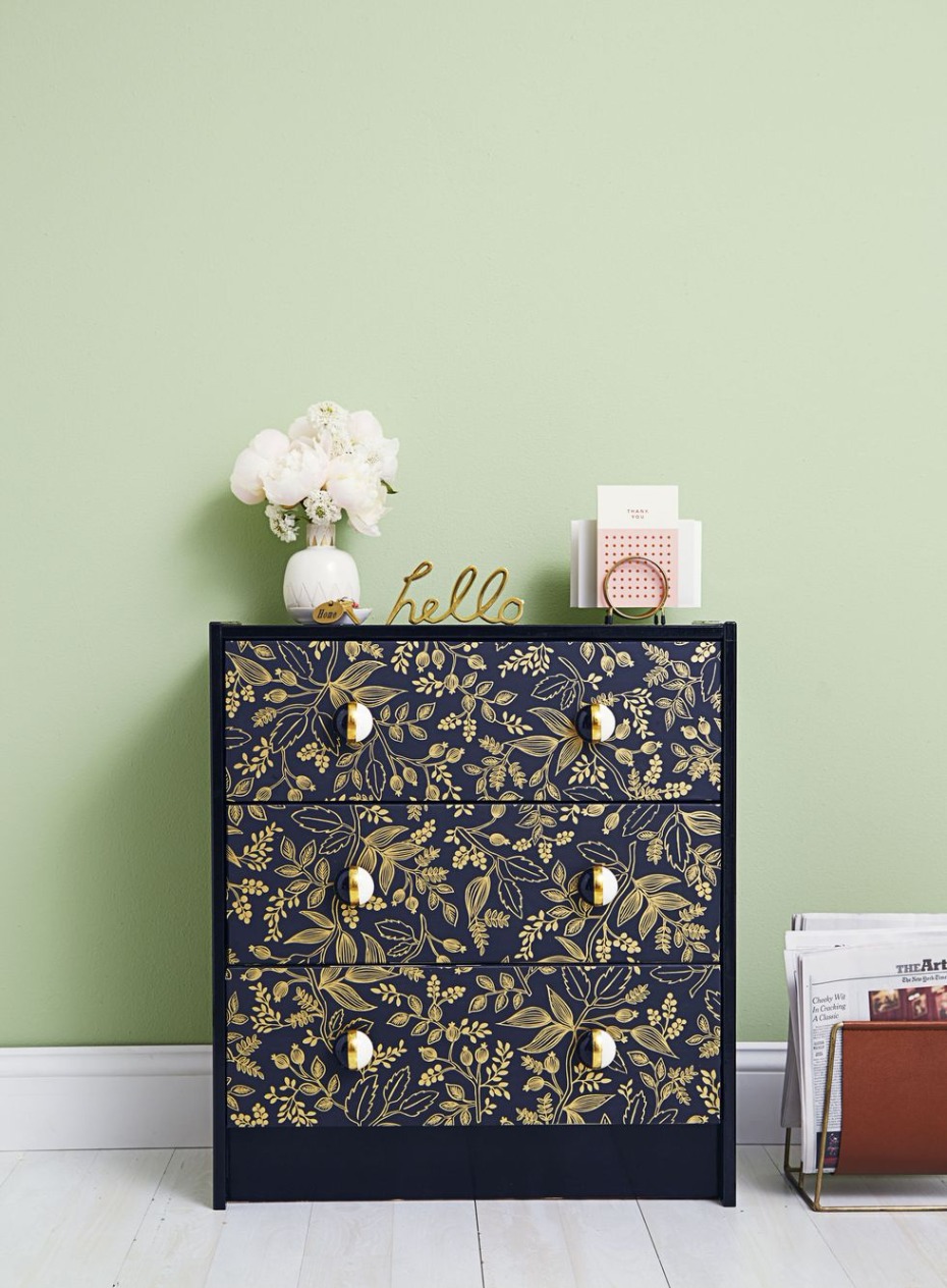 Stylish dresser with gold floral pattern and top decor