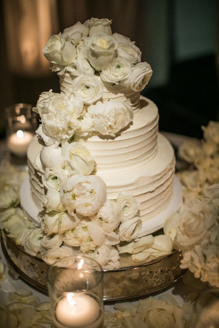all white floral topped wedding cake