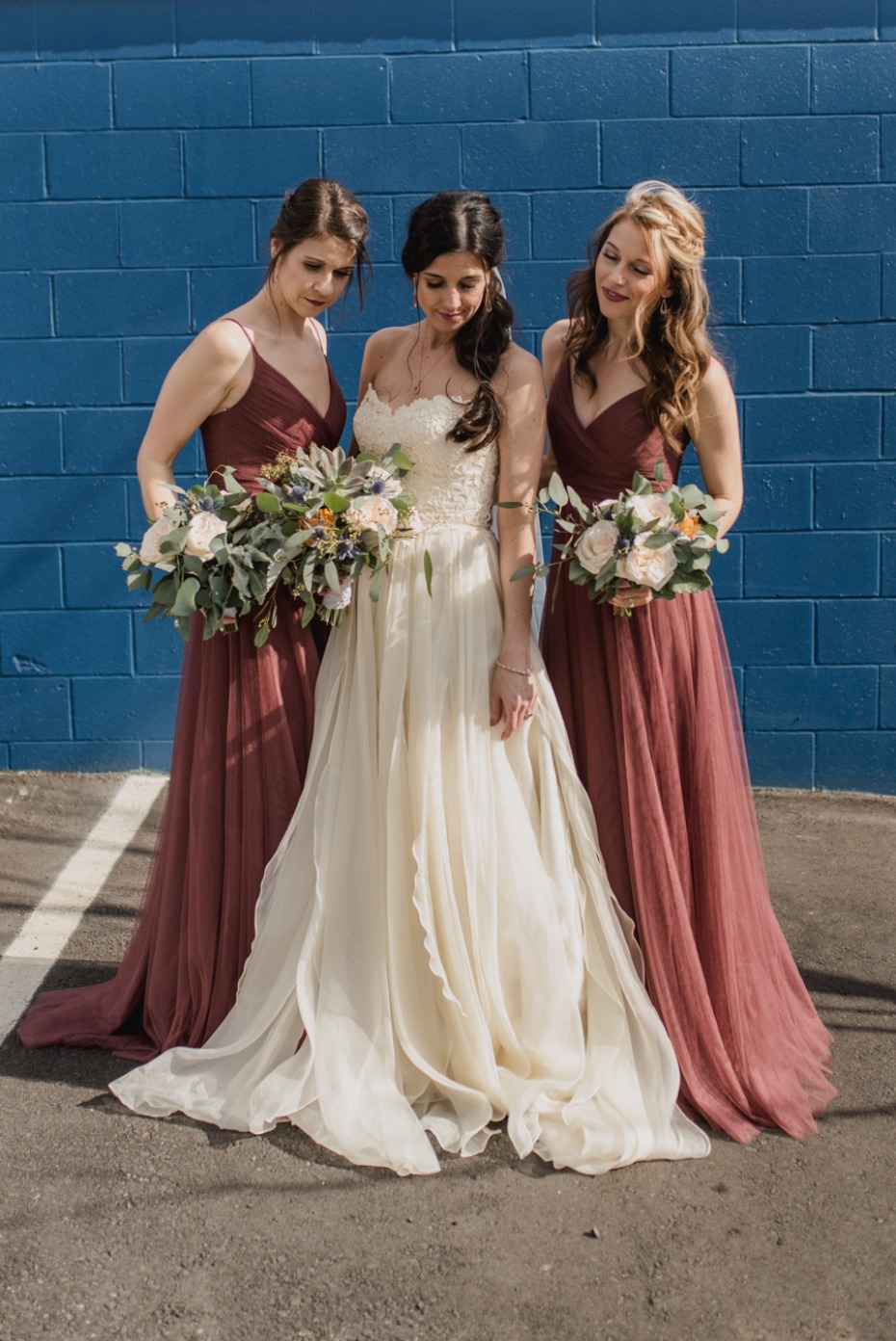 bride and her bridesmaids in marsala dresses