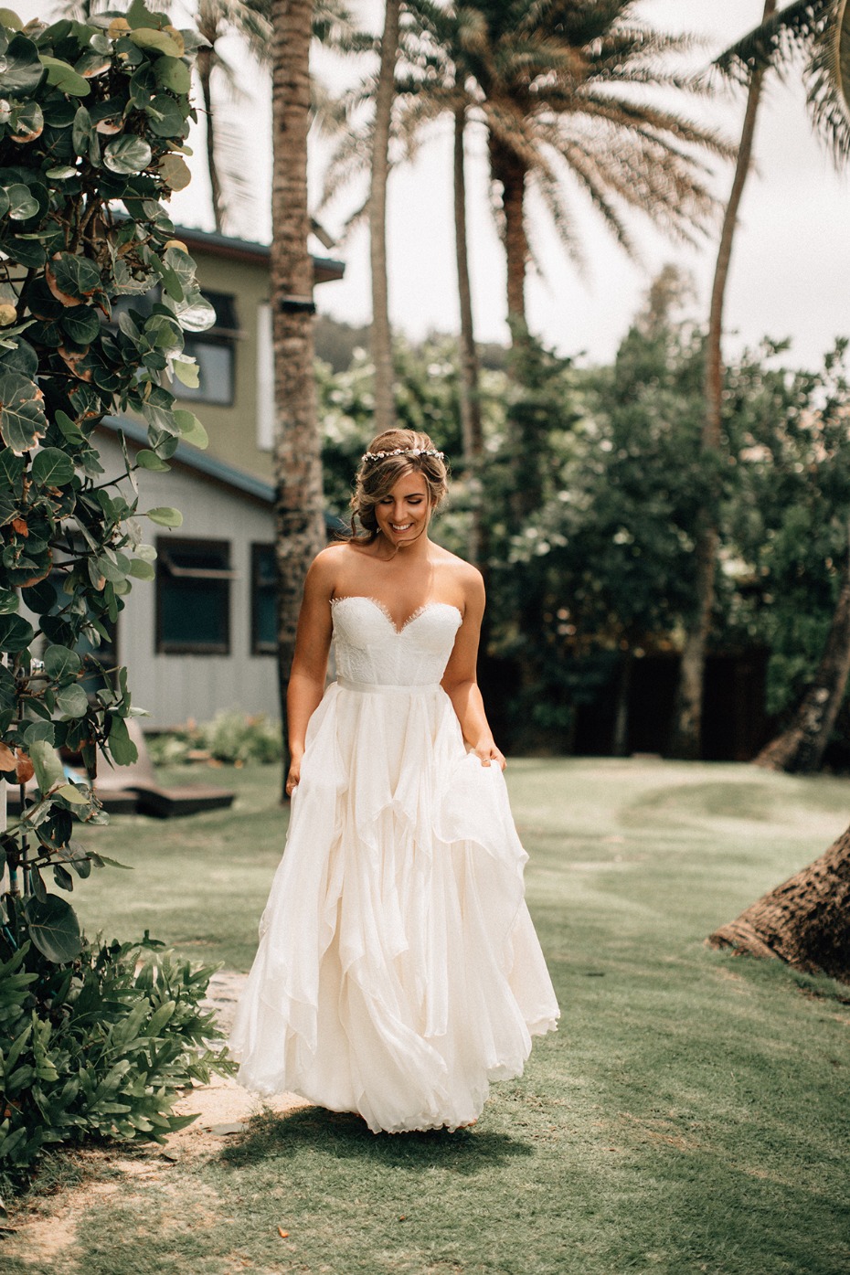 Smiling bride in flowing dress at tropical wedding venue