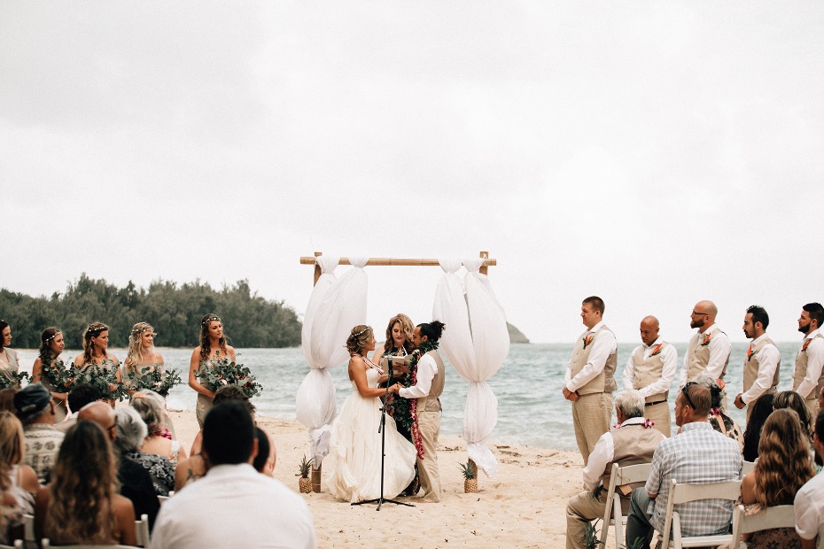 Beach wedding ceremony with bride and groom at altar